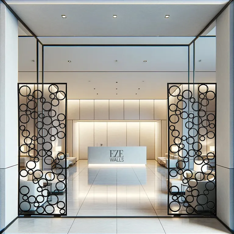 Modern reception area with polished tile floor, white minimalist desk labeled 'EZE WALLS,' and decorative black metal room dividers featuring circular patterns.